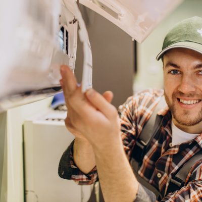 Repairman doing air conditioner servise